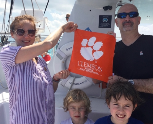 Cayman Islands: Mark Ph.D. \u201910 and Ekaterina \u201cKatya\u201d Yazykova Ph.D. \u201912 Mellott \u2014 who are both senior lecturers in Clemson\u2019s MPA program \u2014 snapped a picture with their Tiger Rag off Grand Cayman Island after snorkeling with the family.
